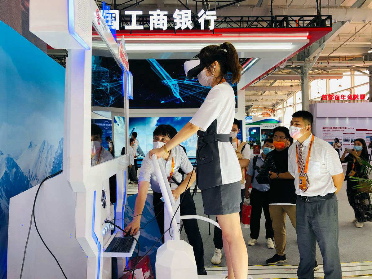 Una donna prova l'esperienza sciatica in realtà virtuale presso lo stand della Bank of China.CIFTIS 2021, 3 Settembre.	