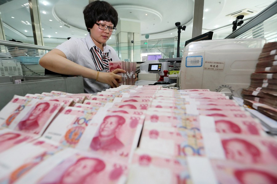 Impiegata conta Renminbi (RMB) presso una banca a Lianyungang, nella provincia cinese del Jiangsu. (Xinhua/Si Wei)