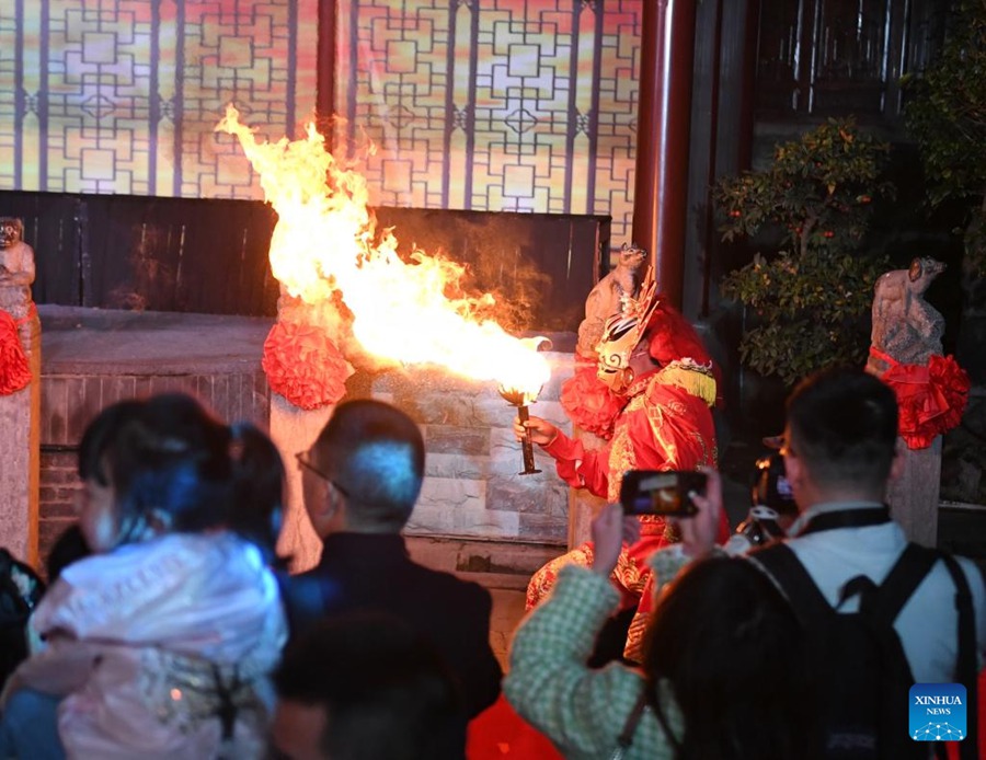 Turisti assistono a uno spettacolo presso un'antico borgo a Langzhong, nella provincia del Sichuan nel sud-ovest della Cina. (20 marzo 2023 – Xinhua/Liu Kun)