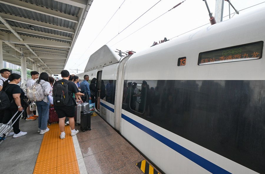 Passeggeri salgono a bordo del treno ad alta velocità G2963 nella stazione ferroviaria di Leshan, nella provincia del Sichuan. (1 luglio 2023 - Xinhua/Wang Xi)