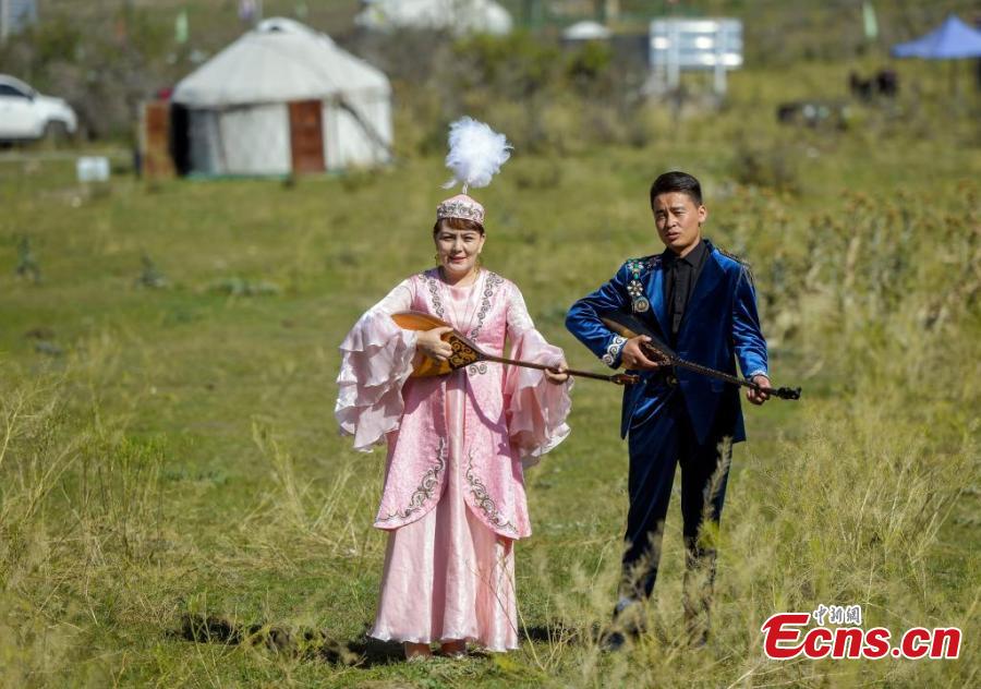 Artisti eseguono canzoni Aken in un parco di Urumqi, nella regione autonoma uigura dello Xinjiang, nel nord-ovest della Cina. (3 agosto 2024 - China News Service/Liu Xin)