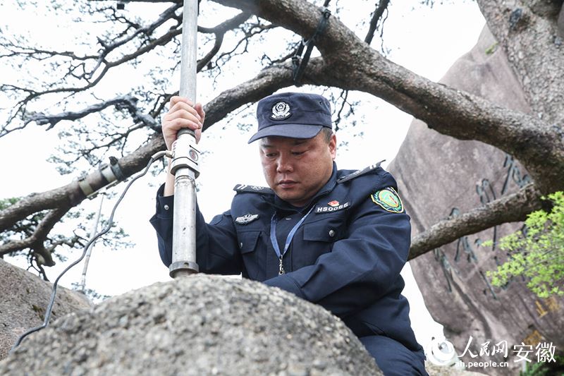 Hu Xiaochun al lavoro su una parete del monte Huangshan. (Quotidiano del Popolo Online/Zhang Jun)